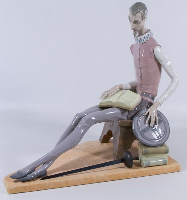 Zaphir by Lladro #0636 'Don Quixote' Figurine: Zaphir by Lladro #0636 'Don Quixote' Figurine Having seated male figure reading books with loose sword and velvet platform Height: 15.00 inches, Width: 18.00 inches Category: Figurines > Lladro Shippi