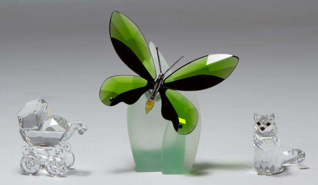 Swarovski Crystal 'Buggy', 'Sitting Cat' and 'Butterfly: Swarovski Crystal 'Buggy', 'Sitting Cat' and 'Butterfly Brooch' Figurines The 'Buggy' was retired in 1999, the 'Sitting Cat' was retired in 2006 Height: 4.50 inches (tallest) Category: Crystal > Swaro