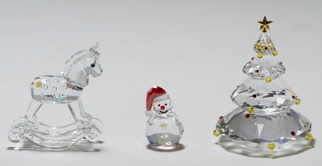 Swarovski Crystal 'Christmas Tree', 'Snowman' and: Swarovski Crystal 'Christmas Tree', 'Snowman' and 'Rocking Horse' Figurines All having colored crystal accents Height: 3.00 inches (tallest) Category: Crystal > Swarovski Shipping Status: Leonard Auct