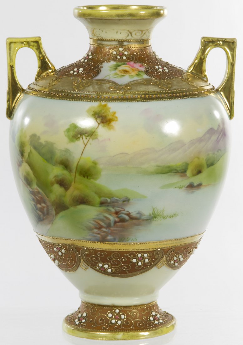 Nippon Porcelain Scenic Double Handled Vase: Nippon Porcelain Scenic Double Handled Vase Having a pastel color landscape scene on light green ground decorated with moriage and gilt; marked with a hand painted blue maple leaf Nippon Height: 8.25 