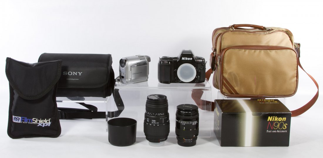 Nikon N90S 35mm Camera and Lenses: Nikon N90S 35mm Camera and Lenses Having an AF Nikkor 28-85mm lens and a Sigma 70-300mm lens; together with Sony Handi-cam Mini-DVD digital video camera Width: 8.00 inches (box) Category: Cameras and