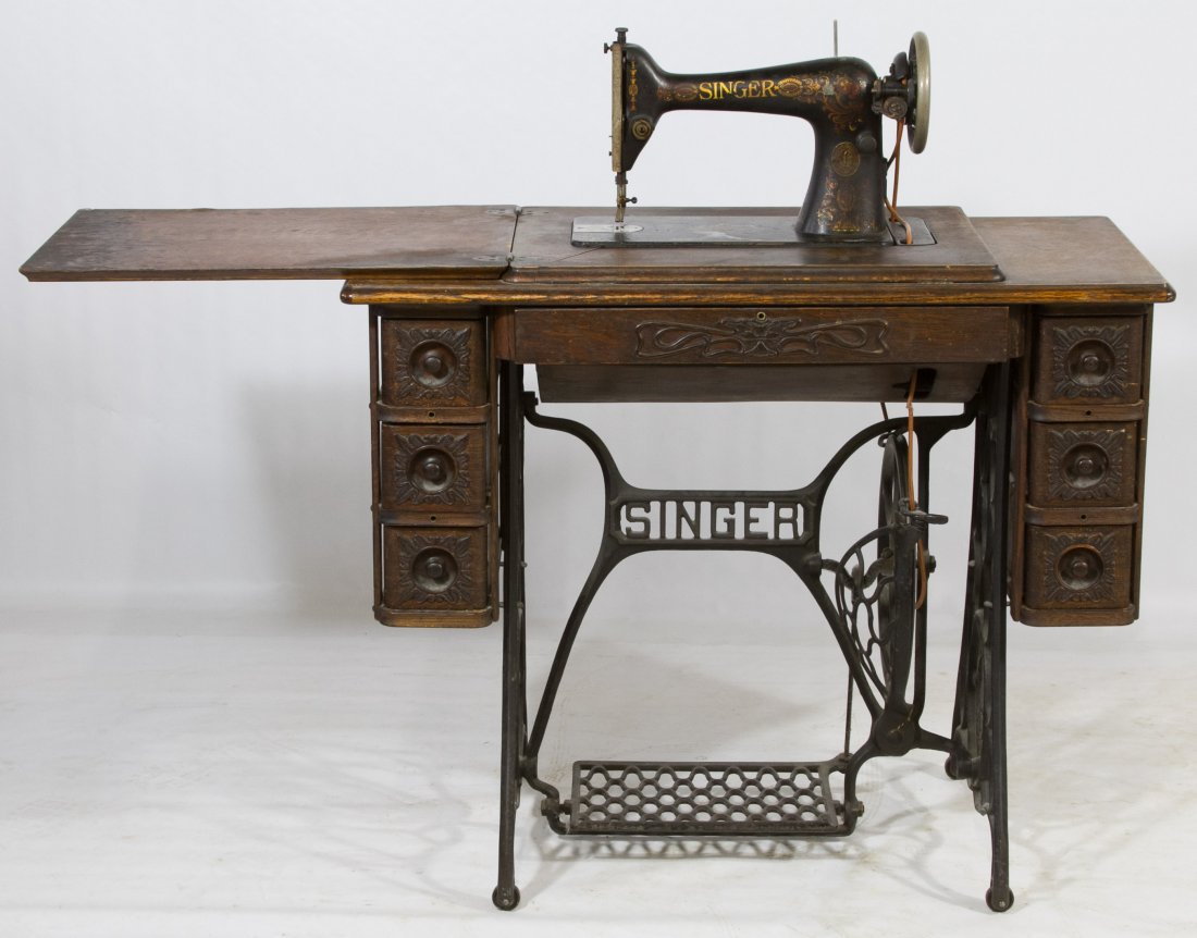 Singer Sewing Pedal Machine: Singer Sewing Pedal Machine c.1910, model #G4619154; having an oak cabinet with cast iron foot pedals Height: 31.00 inches, Width: 36.00 inches, Depth: 18.00 inches Category: Marketplace > Furniture S