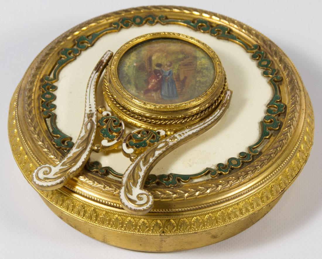 Standing Compact with Hand Painted Scene: Standing Compact with Hand Painted Scene Having a gilt metal base, a lid with enamel decoration on the rim and a hand painted scene of a couple in center Diameter: 5.00 inches Category: Clothing & Acc