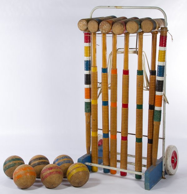 Croquet Set: Croquet Set c.1955, including six wooden mallets, six wooden balls, two wooden posts, nine metal hoops and a metal stand with plastic wheels Height: 26.50 inches (stand) Category: Sporting Goods > Oth