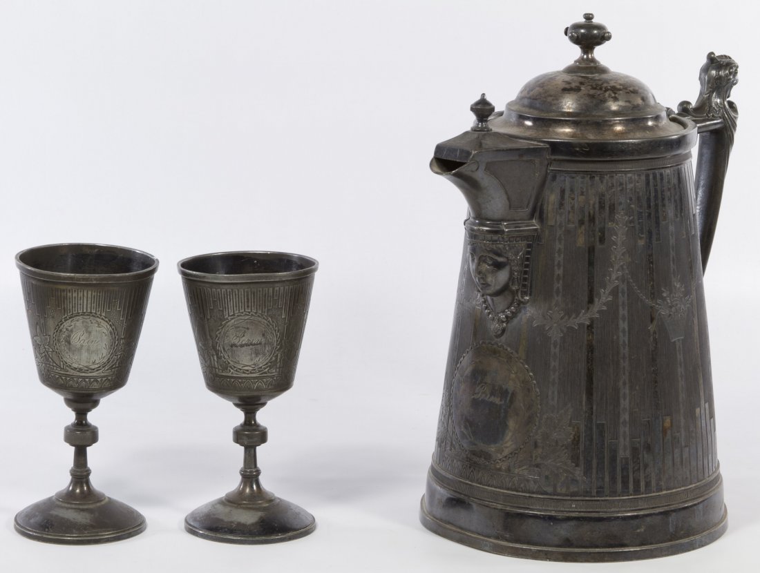 Victorian Reed & Barton Silverplate Water Pitcher and: Victorian Reed & Barton Silverplate Water Pitcher and Goblets Including two goblets and a water pitcher with a gargoyle finial on handle, Egyptian Revival mask face at base of spout and a 'Jas. Stimso