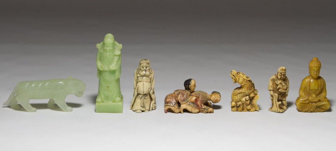 Ivory, Bone and Resin Netsukes and Small Figurines: Ivory, Bone and Resin Netsukes and Small Figurines Seven items including an ivory netsuke figure of a male, a dragon netsuke, a male figure holding a rabbit, an erotic couple, a stone Buddha and two g