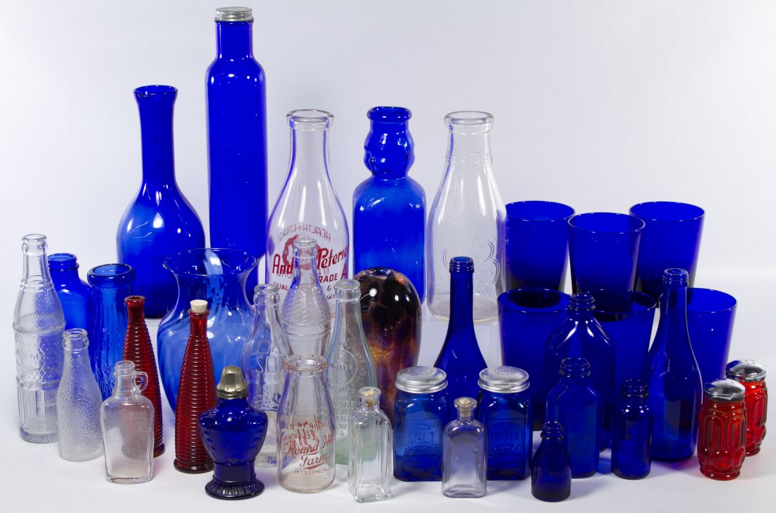 Glass Assortment: Glass Assortment Blue, clear and amber color glass bottles, shakers, a rolling pin, soda bottles and vases Height: 10.50 inches Category: Glass > Pressed Glass Shipping Status: 3rd Party Shipping; the