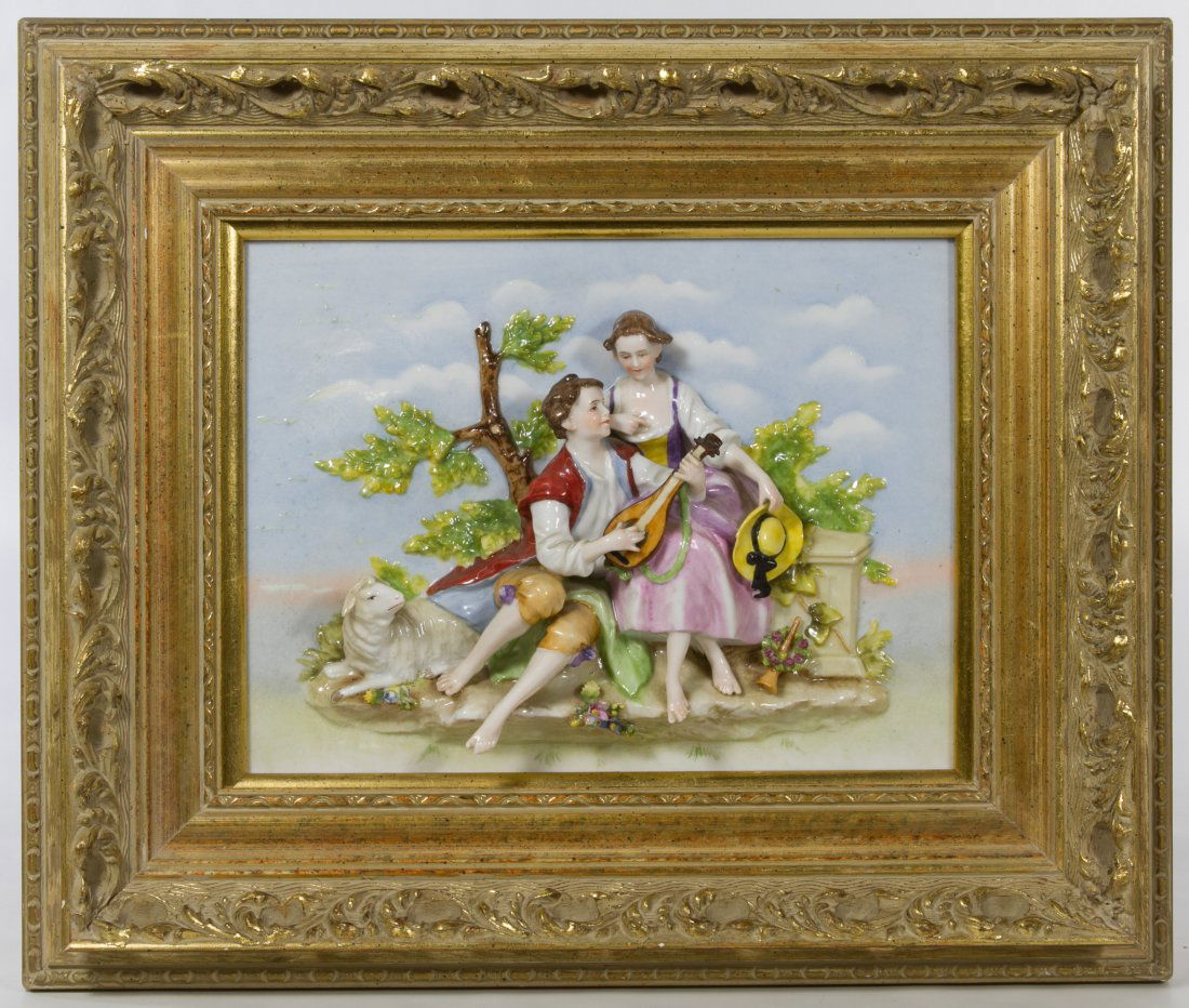 German Porcelain Figural Wall Hanging: German Porcelain Figural Wall Hanging Having an 18th century style couple playing music in a pastoral setting, framed in gilt wood; marked 'Made in Germany' en verso Height: 8.00 inches, Width: 10.00