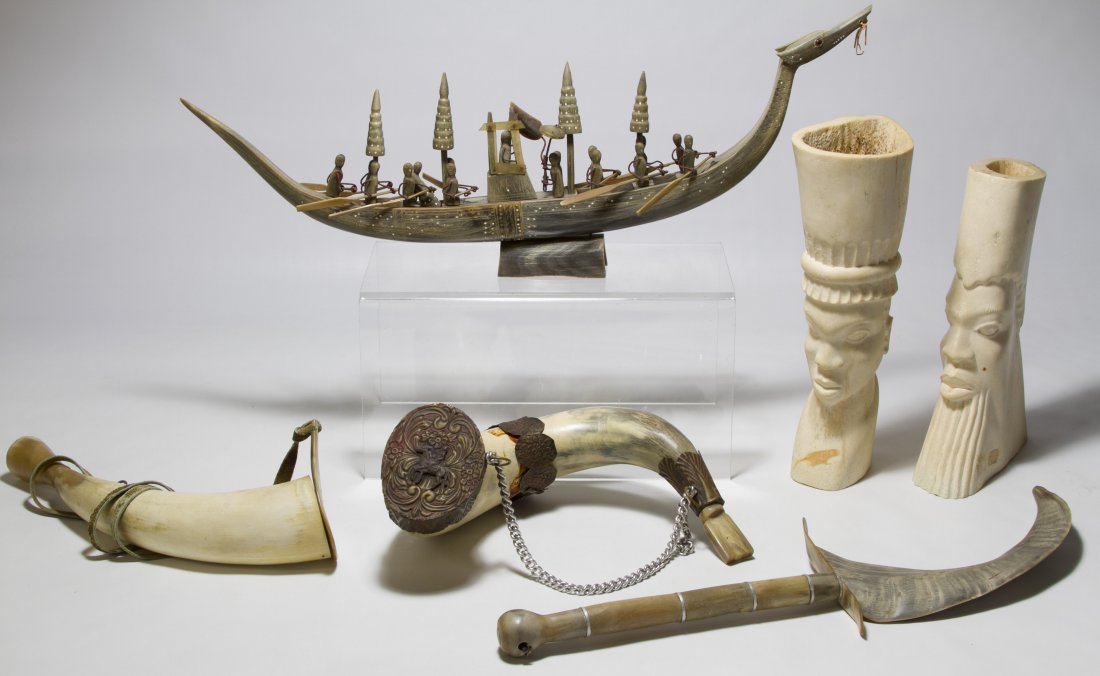 Tribal Art Assortment: Tribal Art Assortment Including male heads made out of bone, two horns, a sword horn and a dragon boat with people Width: 22.00 inches (widest) Category: Decorative Arts > Ethnographic Shipping Status