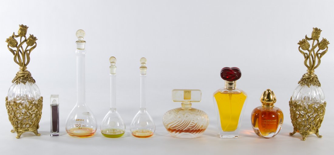 Perfume Bottle Assortment: Perfume Bottle Assortment Nine bottles filled with perfume including a pair with metal mounts and stoppers, two 'Pyrex' marked bottles, a 'Kimax' bottle, an 'Il Bacio' bottle, an Elizabeth Arden bottl