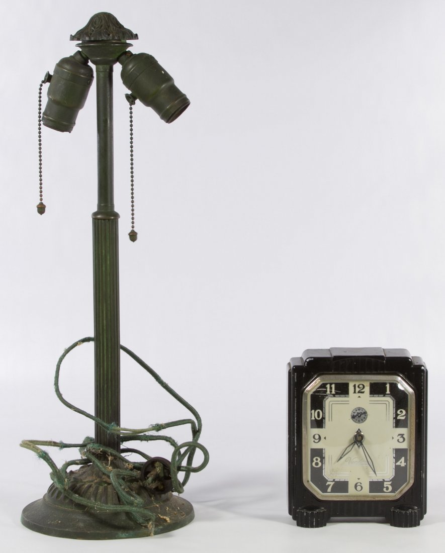 Table Lamp and Clock: Table Lamp and Clock Two items including a 1920s cast metal electric lamp base and an Art Deco 'Vendome' alarm clock by Lux Clock Mfg. Co. Height: 19.50 inches Category: Decorative Arts > Lamps Shippi