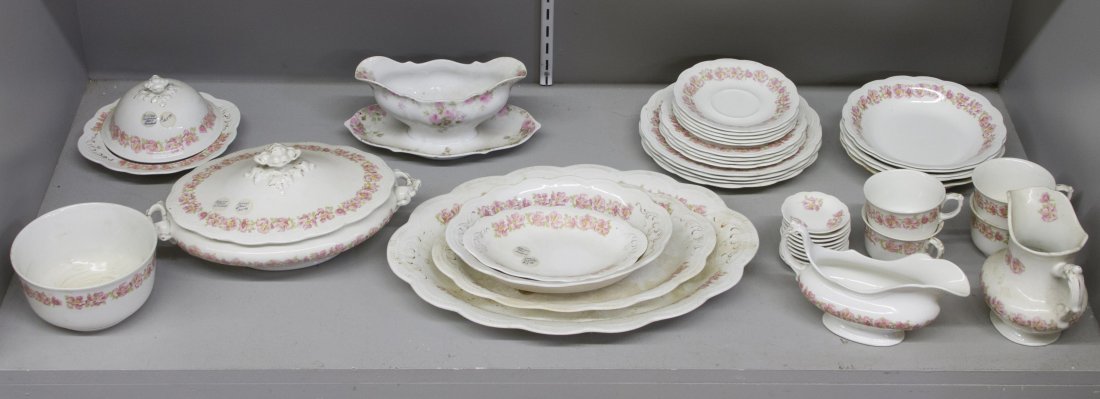 Johnson Bros. England China Service: Johnson Bros. England China Service Including (4) dinner plates, (4) cups, (5) saucers, (5) salad bowls, (4) bread plates, (11) butter pats, a small bowl, a small platter, a medium platter, a large pl