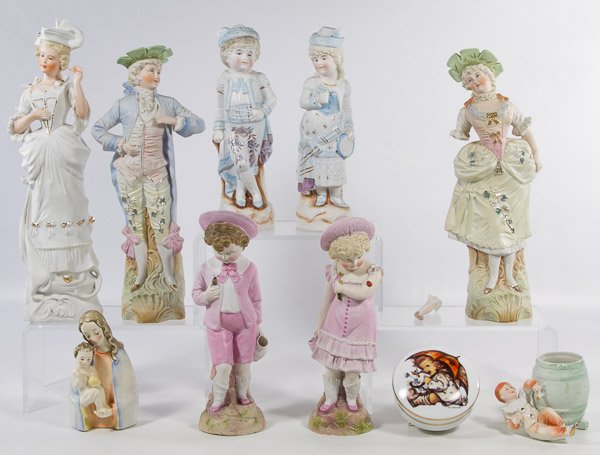 Figurine Assortment: Figurine Assortment Ten items including a Hummel Madonna and Child (TMK #2), a Hummel 'Umbrella Girl' trinket box, two child figurines in pink with incised mark '1264,' a '7989' marked clown with barr
