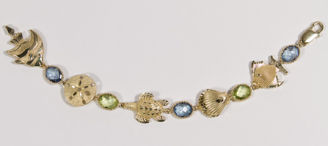 14k Gold 'Under the Sea' Bracelet: 14k Gold 'Under the Sea' Bracelet Having fish, turtle, shell and sand dollar separated by semi-precious stones Length: 7.75 inches Weight: 9.77 dwts. (total weight) Category: Jewelry and Timepieces > 