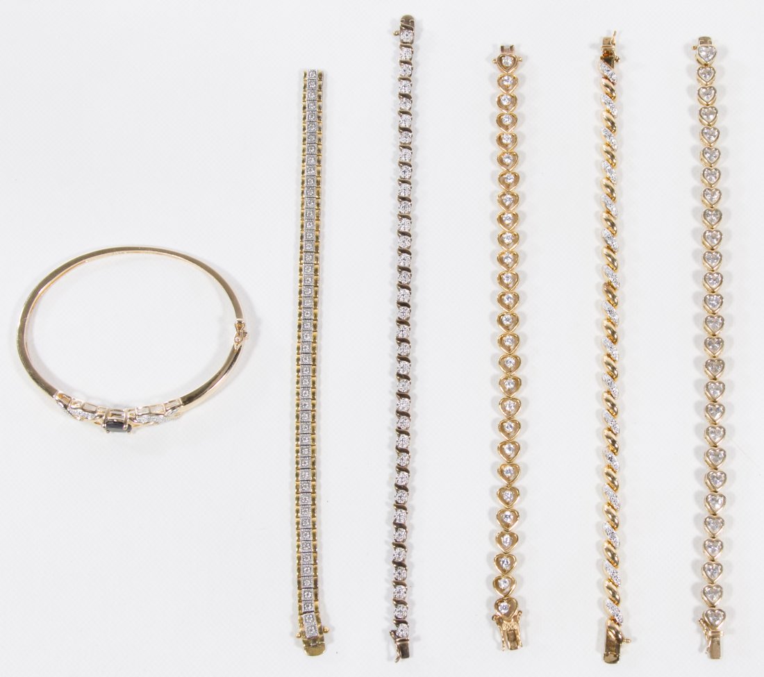 Sterling Silver Bracelet Assortment: Sterling Silver Bracelet Assortment Six gold vermeil pieces including five chain bracelets with one having diamonds chips and two others having crystals and a bangle bracelet having an oval cut sapphi