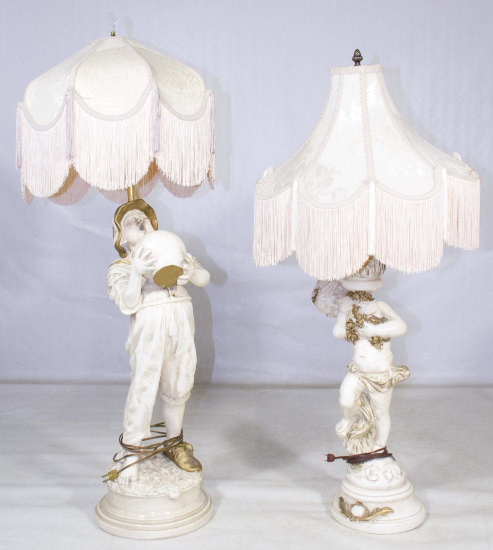 Figural Table Lamps: Figural Table Lamps Two unmarked plaster lamps with fringed shades and child figures holding flowers or a bottle Height: 47.00 inches (tallest) Category: Decorative Arts > Lamps Shipping Status: Due t