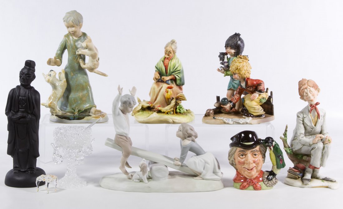 Ceramic Figurine Assortment: Ceramic Figurine Assortment Seven items including a Capodimonte Bocce ball, an unmarked angel with dog and cat ceramic, a black painted Asian elder, Nao children playing on a teeter totter, an A. Bors