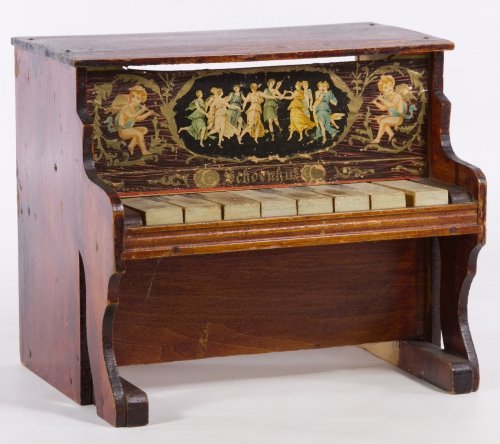 Schoenhut Toy Piano: Schoenhut Toy Piano Having the original chromolithograph of dancing females and musical cherubs, the Schoenhut name, 8 keys and the original finish Height: 8.00 inches, Width: 9.00 inches, Depth: 7.00