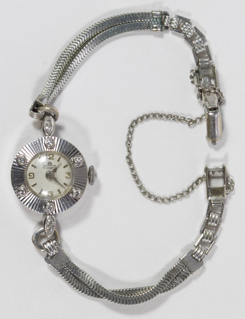 Bucherer 18k Gold and Diamond Cased Wrist Watch: Bucherer 18k Gold and Diamond Cased Wrist Watch Serial #25234 having a 21 jewel and 4 adjustment movement on a gold plated band made by Kreisler with a safety latch and chain; together with a Bucherer