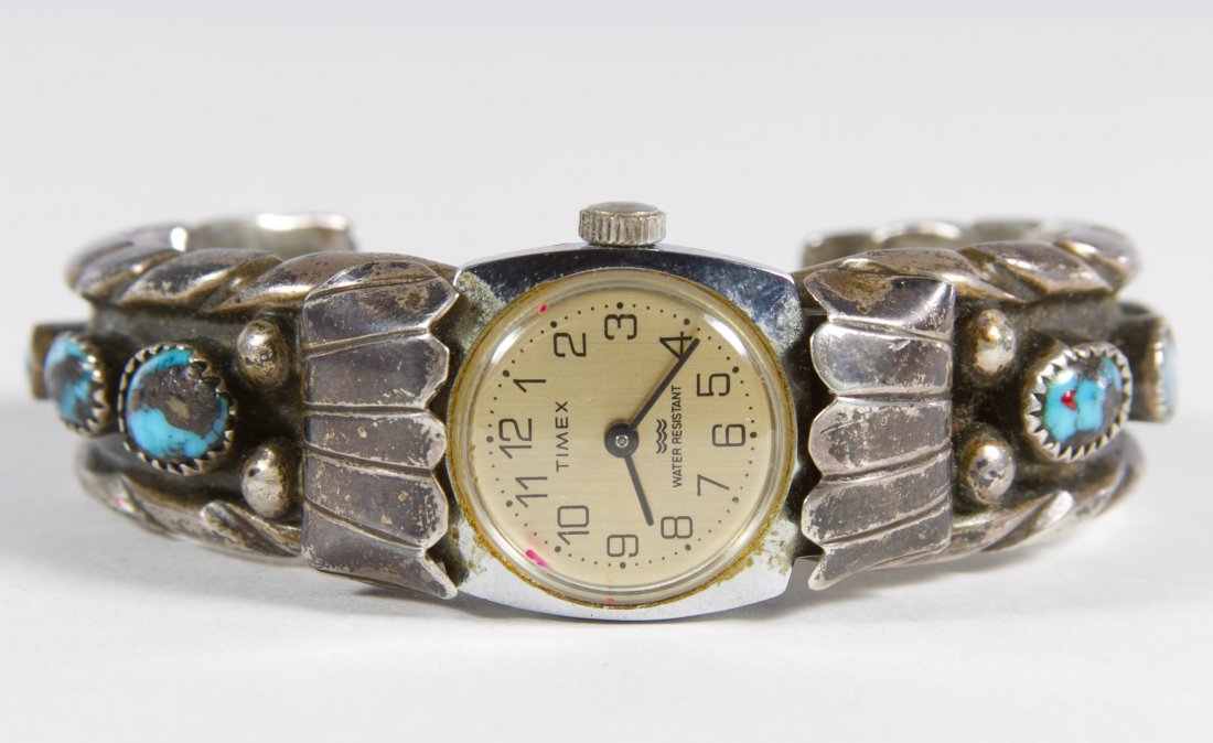 Sterling Silver Watch Band with Timex Watch: Sterling Silver Watch Band with Timex Watch Cuff band signed NC and decorated with six oval cut turquoise Length: 6.50 inches (inside band) Weight: 48.16 dwts. (total weight) Category: Jewelry and Tim