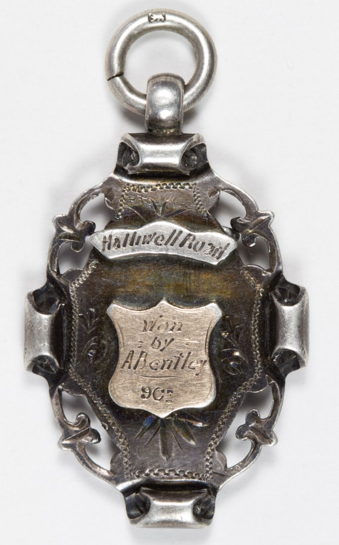 1896 Sterling Silver Halliwell Road Bicycle Race: 1896 Sterling Silver Halliwell Road Bicycle Race Pendant Having 9ct gold shields; labeled 'Won by A. Bentley'; stamped hallmarks on the bottom; Serial #R226552 Length: 2.00 inches Weight: 0.47 ozt. (t