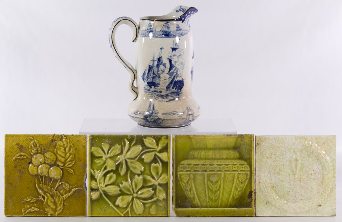 Buffalo Pottery 'John Paul Jones' Pitcher: Buffalo Pottery 'John Paul Jones' Pitcher Blue and white patriotic pitcher; together with four tiles including two 'Trent', a fleur-de-lis motif and a cherry blossom Height: 9.25 inches (pitcher) Cate