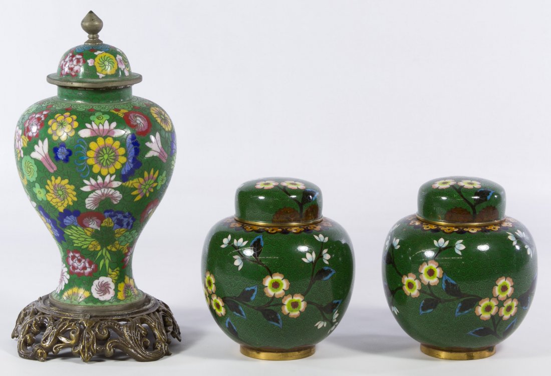 Green Cloisonne Ginger Jars: Green Cloisonne Ginger Jars Three brass footed items with 'CHINA' underside marks including a matched pair of ovoid jars having a floral design and a larger jar with a detached metal stand Height: 9.0