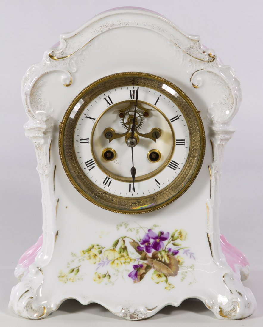French Porcelain Mantel Clock by Marti et Cie: French Porcelain Mantel Clock by Marti et Cie Having a Rococo style porcelain body with printed floral images, an exposed escapement, a French back plate mark and 'KPM' and 'Made in France' marks on t