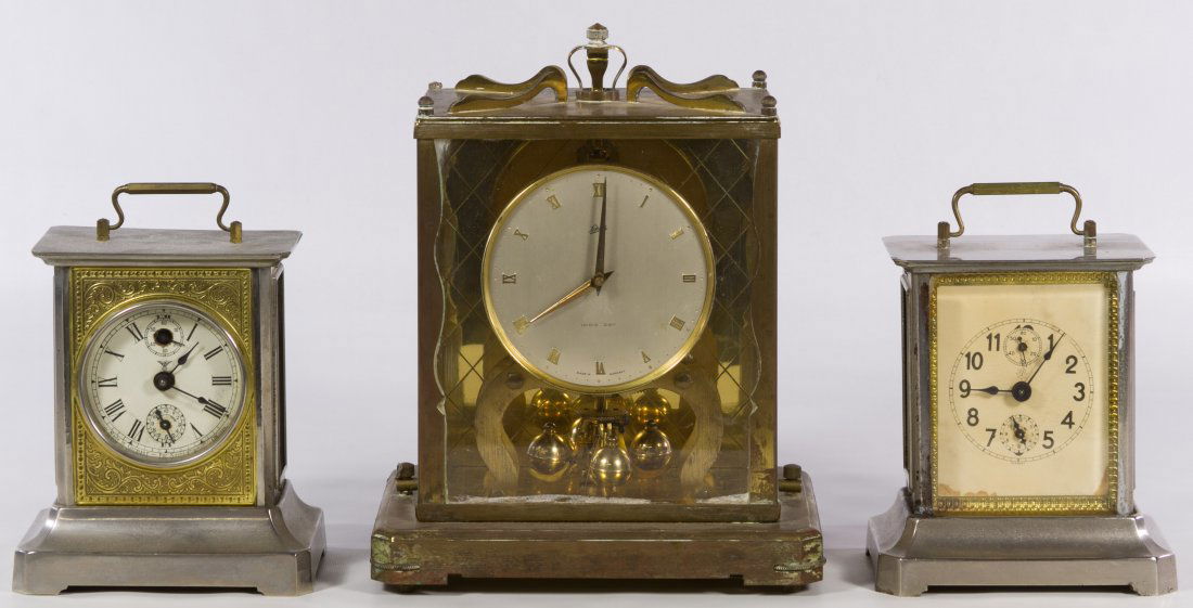 German Metal Clock Assortment: German Metal Clock Assortment Three items including an Schatz '1000 Day' brass and glass clock, a 'Little Dolly Daydream' carriage clock made in Germany for Kuehl Clock Co. of Chicago and a Unghans ca