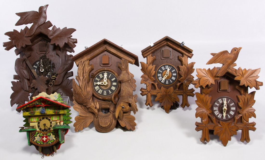 German Cuckoo Clocks by Schmeckenbecher: German Cuckoo Clocks by Schmeckenbecher Four clocks; together with one cuckoo clock, six pendulums, four weights, five cuckoo chime parts and one back of a cuckoo clock Height: 14.00 inches, Width: 9.
