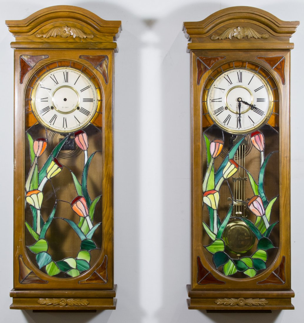 Stained Glass Wall Clocks: Stained Glass Wall Clocks 20th Century, having floral motifs, both have 31 Day clock faces and keys Height: 37.00 inches, Width: 13.50 inches, Depth: 6.00 inches Category: Decorative Arts > Clocks Shi