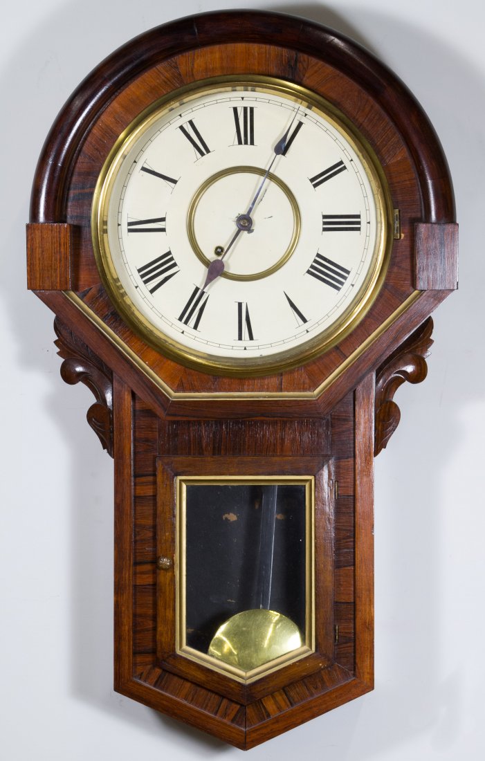 Classical Mahogany Inlay Wall Clock: Classical Mahogany Inlay Wall Clock Late 19th Century, having a metal face; including key and pendulum Height: 32.00 inches, Width: 18.50 inches, Depth: 5.00 inches Category: Decorative Arts > Clocks 