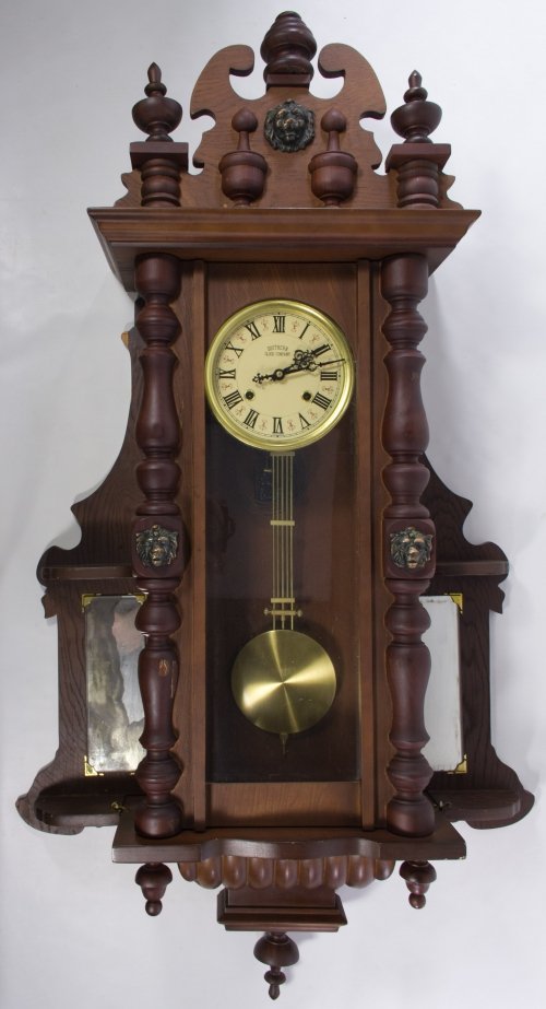 Mahogany Wall Clock by the Southern Clock Co: Mahogany Wall Clock by the Southern Clock Co 19th Century, having lion head motif and two side panel mirrors; including pendulum and key Height: 48.00 inches, Width: 28.00 inches, Depth: 8.00 inches C