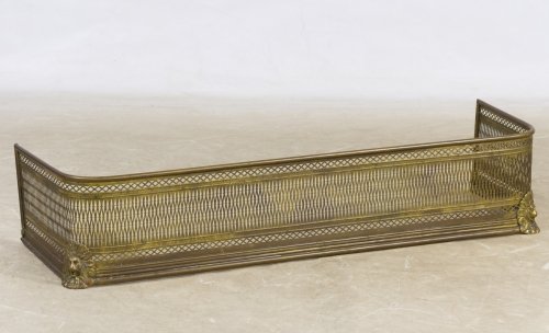 Pierced Brass Fireplace Fender: Pierced Brass Fireplace Fender c.1900, having lion head and feet on front corners Height: 9.00 inches, Width: 42.50 inches, Depth: 13.00 inches Category: Decorative Arts > Objects Shipping Status: Due