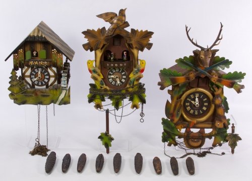 Carved Cuckoo Clocks by Schmeckenbecher: Carved Cuckoo Clocks by Schmeckenbecher Three clocks including 'Wiener Biut' number 1018, 'Rosen aus dem Suden' number 1004 and 'Rigolette'; including nine weights and two pendulums Height: 18.00 inch