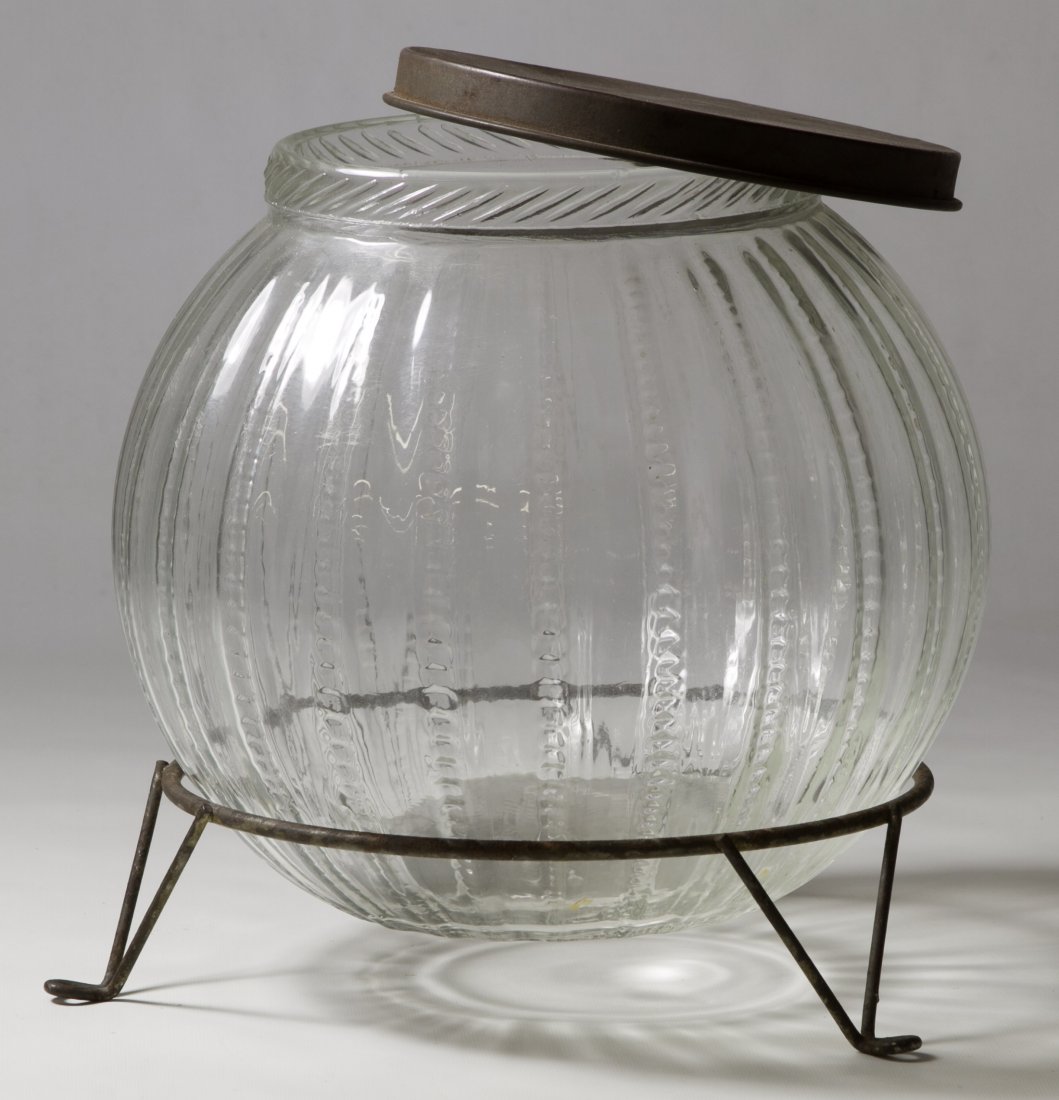 Counter-top Candy Display Jar: Counter-top Candy Display Jar Having a round pressed glass body, a metal lid and a metal tripod support Height: 8.50 inches Category: Collectibles > Food Shipping Status: Due to size, weight, value or