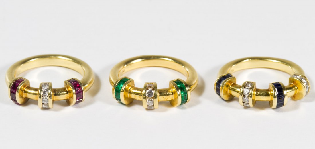 18k Gold, Semi-Precious and Diamond Stacking Ring Set: 18k Gold, Semi-Precious and Diamond Stacking Ring Set Three rings having alternating bands of ruby and diamond, emerald and diamond and sapphire and diamond Size: 6.5 Weight: 16.08 dwts. (total weight
