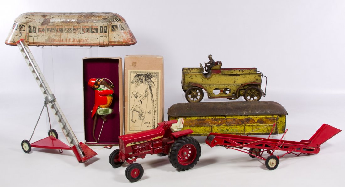 Tin Toy Assortment: Tin Toy Assortment Including a 'Steamline Railway' push toy, a 'Princess' car, a truck, a 1980 era 'Curt' the monkey reproduction toy in original box and an International tractor; together with truck