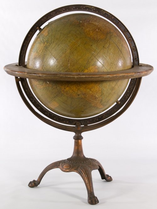 Terrestrial Globe on Metal Footed Stand: Terrestrial Globe on Metal Footed Stand c.1900, made in England, sold through Marshall Field as a 12 inch school classroom globe; having paper veneer over wood, metal and wood rings and copper tone fo