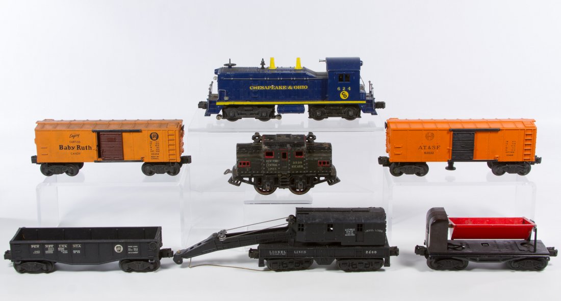 Bing and Lionel O-Gauge Train Car Assortment: Bing and Lionel O-Gauge Train Car Assortment Seven items including a Bing cast iron locomotive car #3238, a Lionel plastic engine #624, a Lionel metal car #3559 and plastic Lionel cars #2460,2452, X24