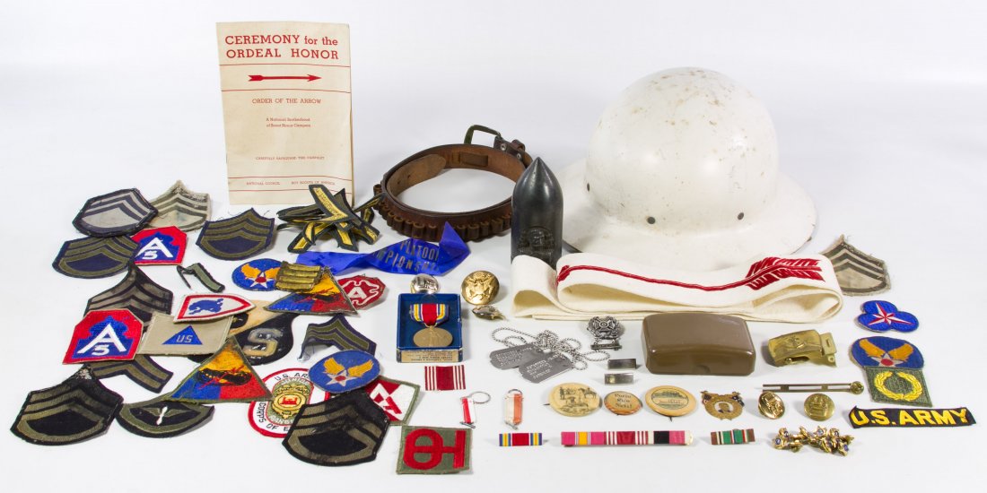 World War II Military Assortment: World War II Military Assortment Including a Civil Defense helmet, World War II era and later patches; together with Spanish American War era pin back buttons, a medal and a trench art portrait shell 