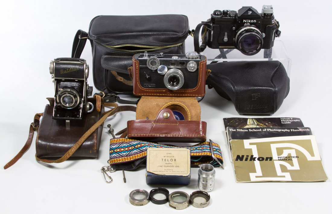 Camera Assortment: Camera Assortment Including an Argus range finder, a Baldina Blende, a Nikon 50mm F and assorted lenses; together with a World War II US Army leather pouch Length: 6.50 inches (Nikon) Category: Camera