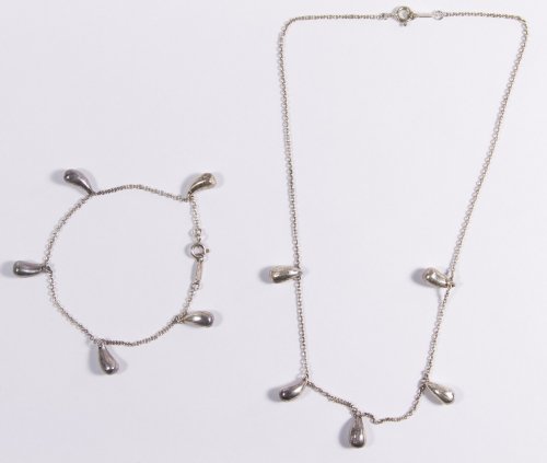 Tiffany & Co Sterling Silver Jewelry by Elsa Peretti: Tiffany & Co Sterling Silver Jewelry by Elsa Peretti Including 'Teardrop' necklace and bracelet, each having five teardrops Length: 15.00 inches (necklace) Weight: 13.57 dwts. Category: Jewelry and Ti