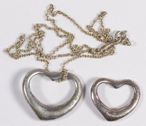 Tiffany & Co. Sterling Silver Heart Pendants by Elsa: Tiffany & Co. Sterling Silver Heart Pendants by Elsa Peretti Two pendants with marks and signatures; one has an attached Tiffany & Co. sterling necklace Length: 16.50 inches (necklace) Weight: 6.04 dw