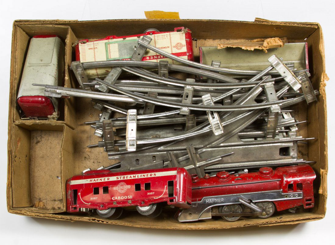 Hafner Wind-Up Train and Marx Train Box: Hafner Wind-Up Train and Marx Train Box Including Hafner engine #1010, four Hafner tin lithographed train cars, a Marx streamline train set box and train track Length: 8.00 inches (engine) Category: T