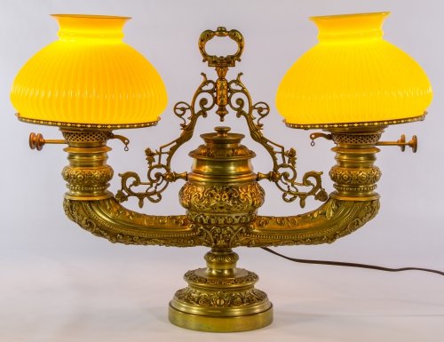 Plume and Atwood 'Harvard' Double Light Student Lamp: Plume and Atwood 'Harvard' Double Light Student Lamp Having an electrified Baroque style heavy brass base, mask face and scroll decoration and two fluted yellow glass shades; 'PA Duplex' marks on burn