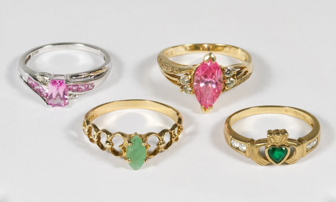 10k Gold and Gemstone Rings: 10k Gold and Gemstone Rings Four rings with one having white gold and pink sapphires, one having yellow gold and emerald and the other two having crystals Size: 6.5 to 8 Weight: 6.11 dwts. (total weig