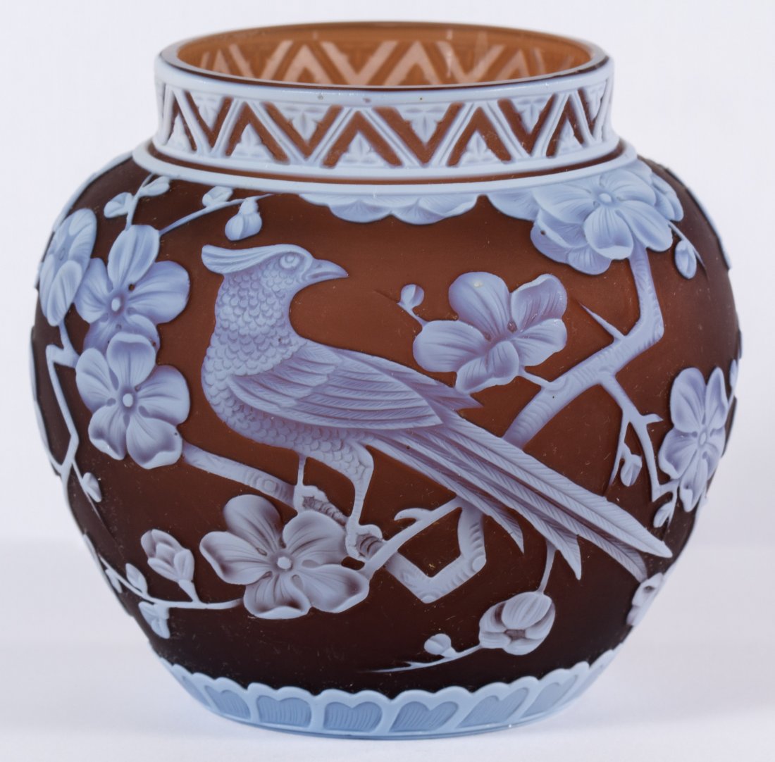Thomas Webb & Sons Cameo Glass Shoulder Vase in Raisin: Thomas Webb & Sons Cameo Glass Shoulder Vase in Raisin Having a pheasant in a dogwood tree motif on raisin color with an intricately decorated Aztec rim; provenance: Maude B. Feld Height: 3.50 inches