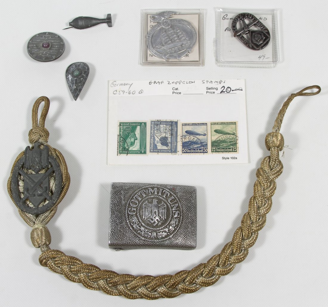 World War II German Nazi Assortment: World War II German Nazi Assortment Including pins, badges and stamps Length: 2.50 inches (belt buckle) Category: Military & Weapons > World War II Shipping Status: Leonard Auction, Inc. will directly