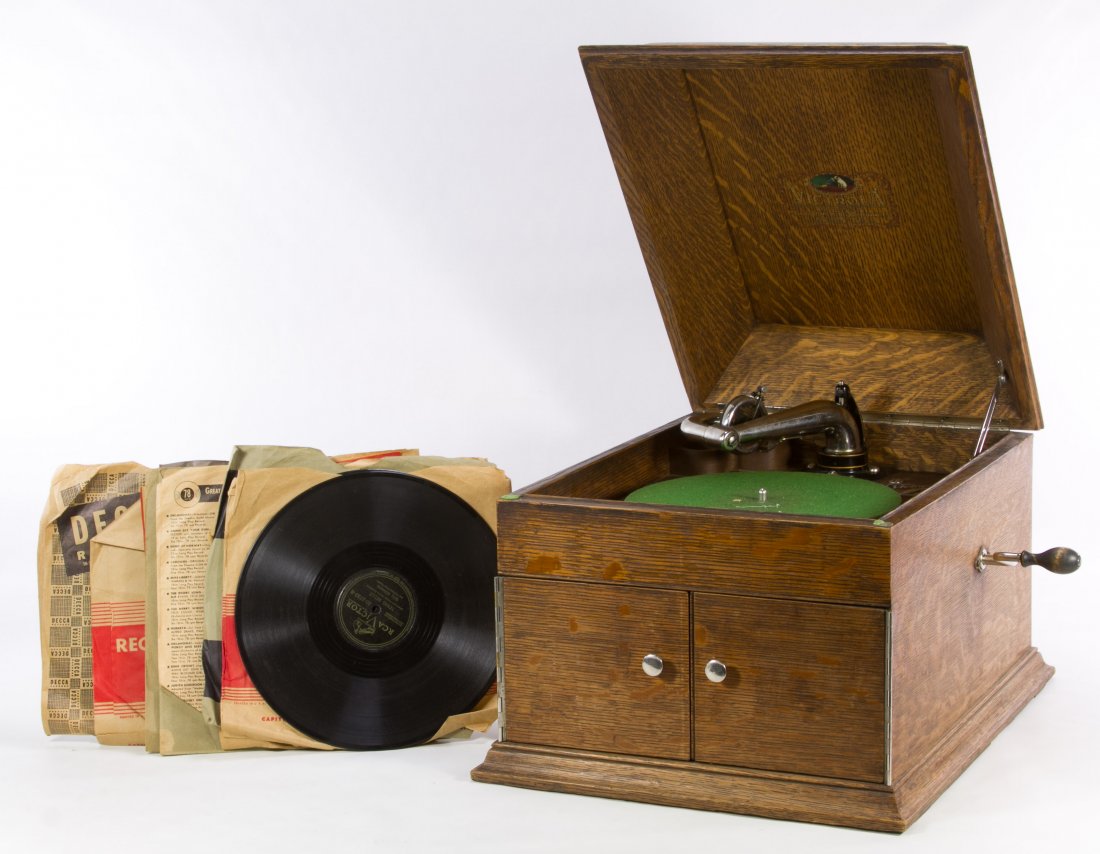 Oak Victrola by Victor Talking Machine Co.: Oak Victrola by Victor Talking Machine Co. 1904, serial #VV-VIII-A 96539, having two pullout doors; together with forty-eight records and a Bismarck, ND Library Commission storage chest Height: 13.25